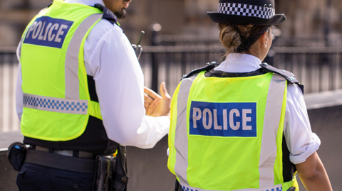A policeman talking to a police woman